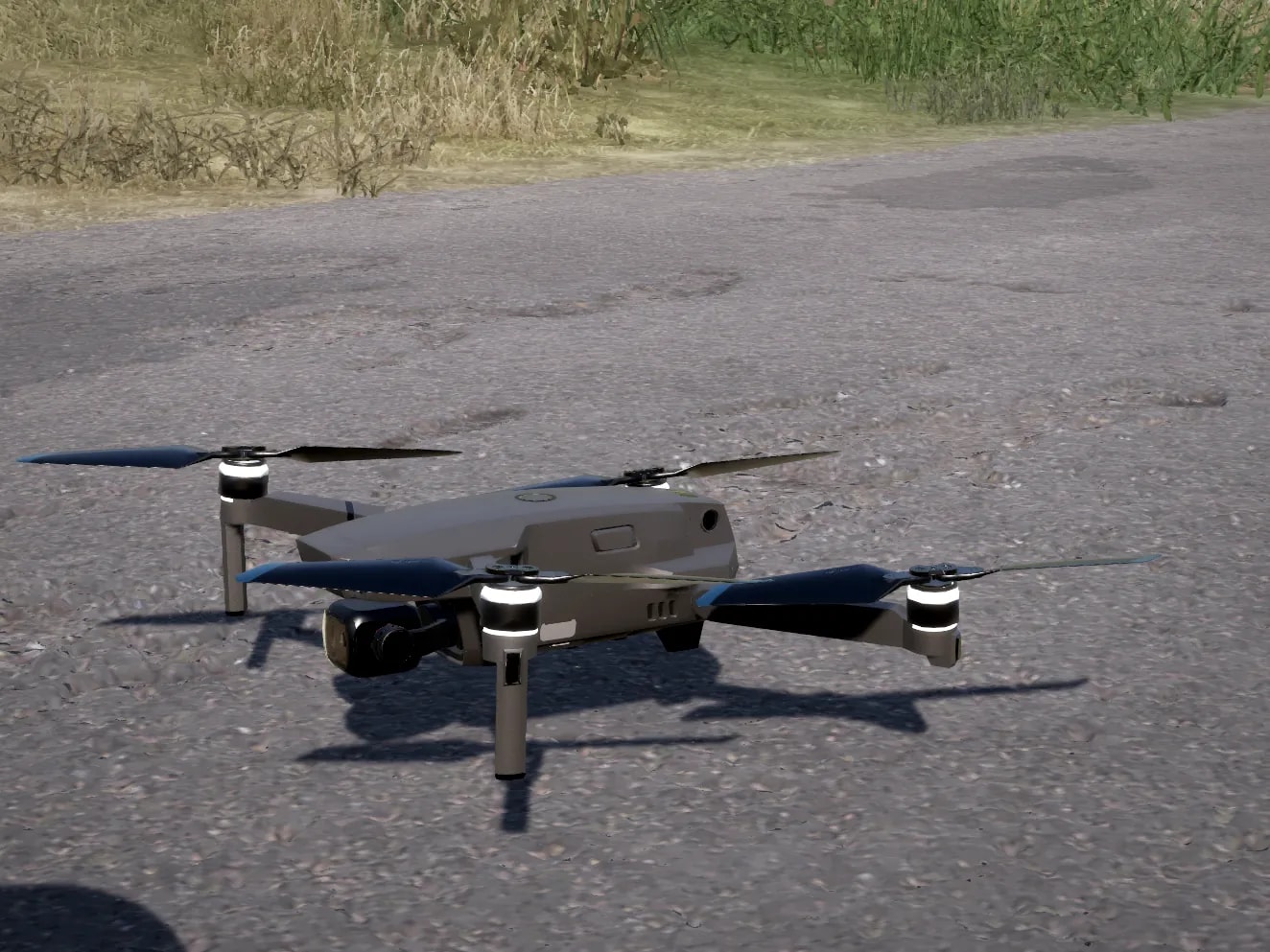 Drone de reconhecimento cinza, dobrável, com câmera estabilizada na frente, pousado no asfalto